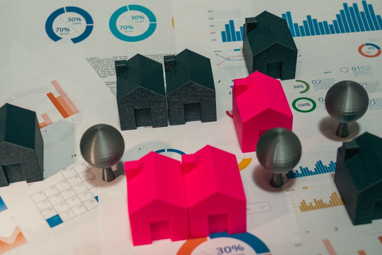 Mastering the First Impression: Your intriguing post title goes here Abstract representation of real estate market analysis with model houses and charts.